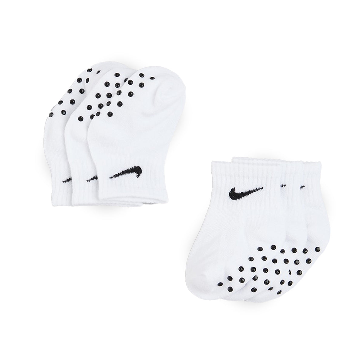 White and black Nike Core Swoosh gripper socks for infants with non-slip soles.